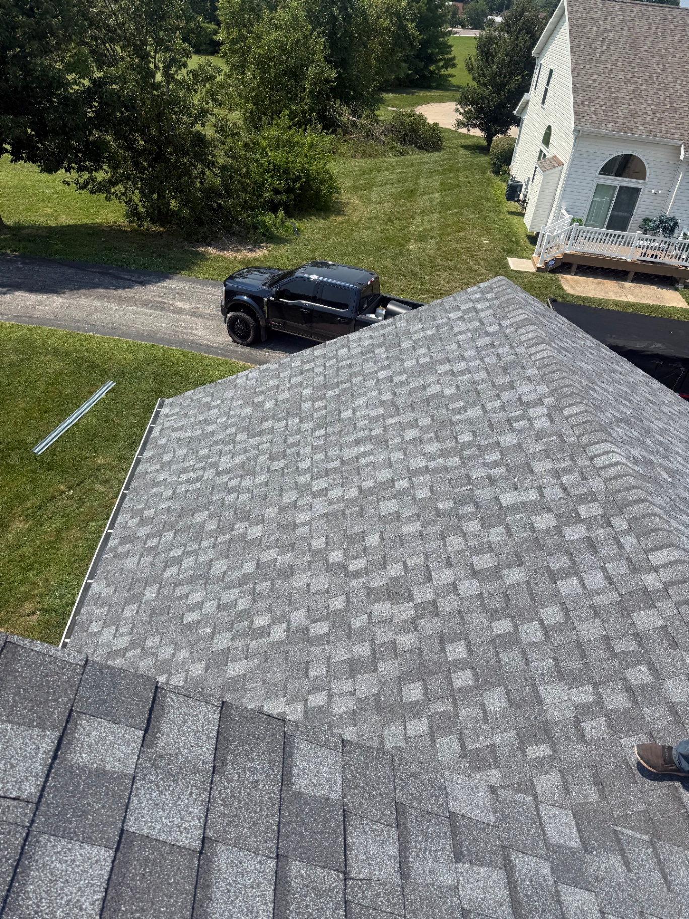 Finished pewter shingle roof with new drip edge on a residential home