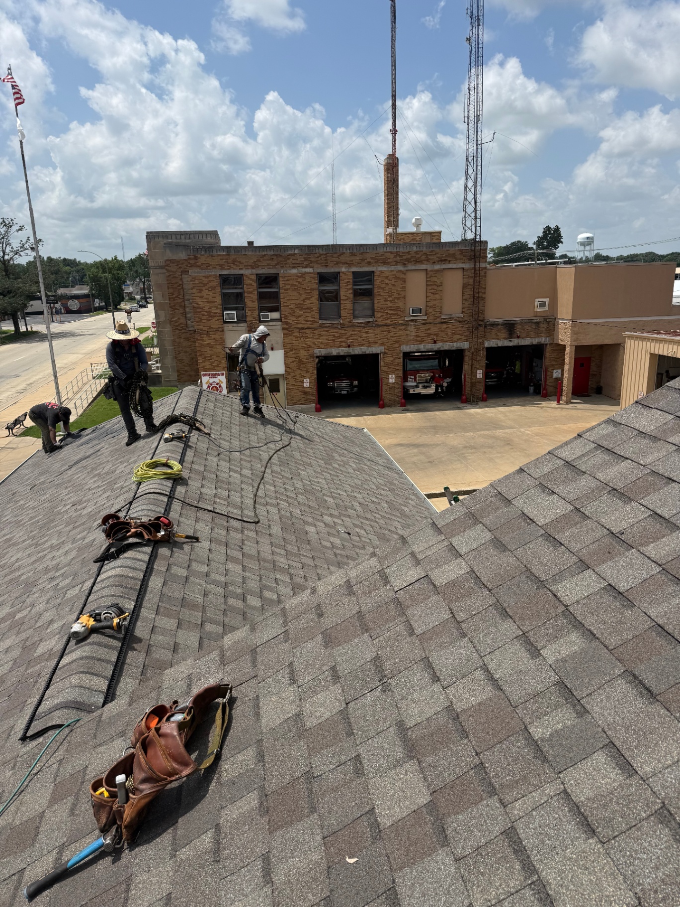 Crew shingling a municipal fire station roof